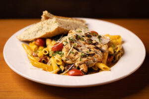 grilled chicken on pasta with vegetables